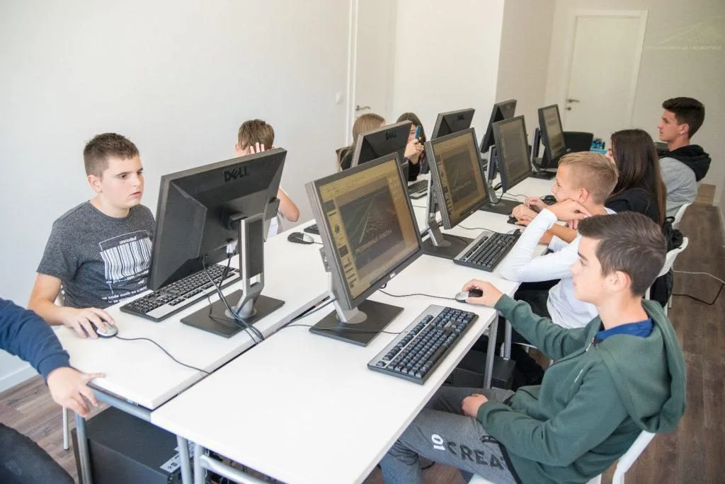 Children in the IT Clever computer room, each at their own machine