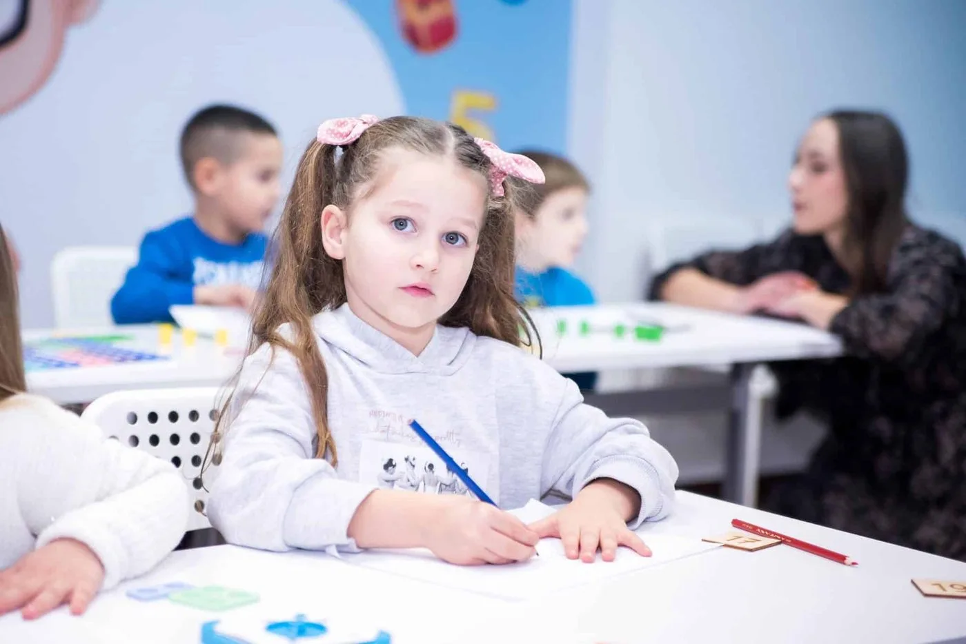 A group of the youngest children at a table during class