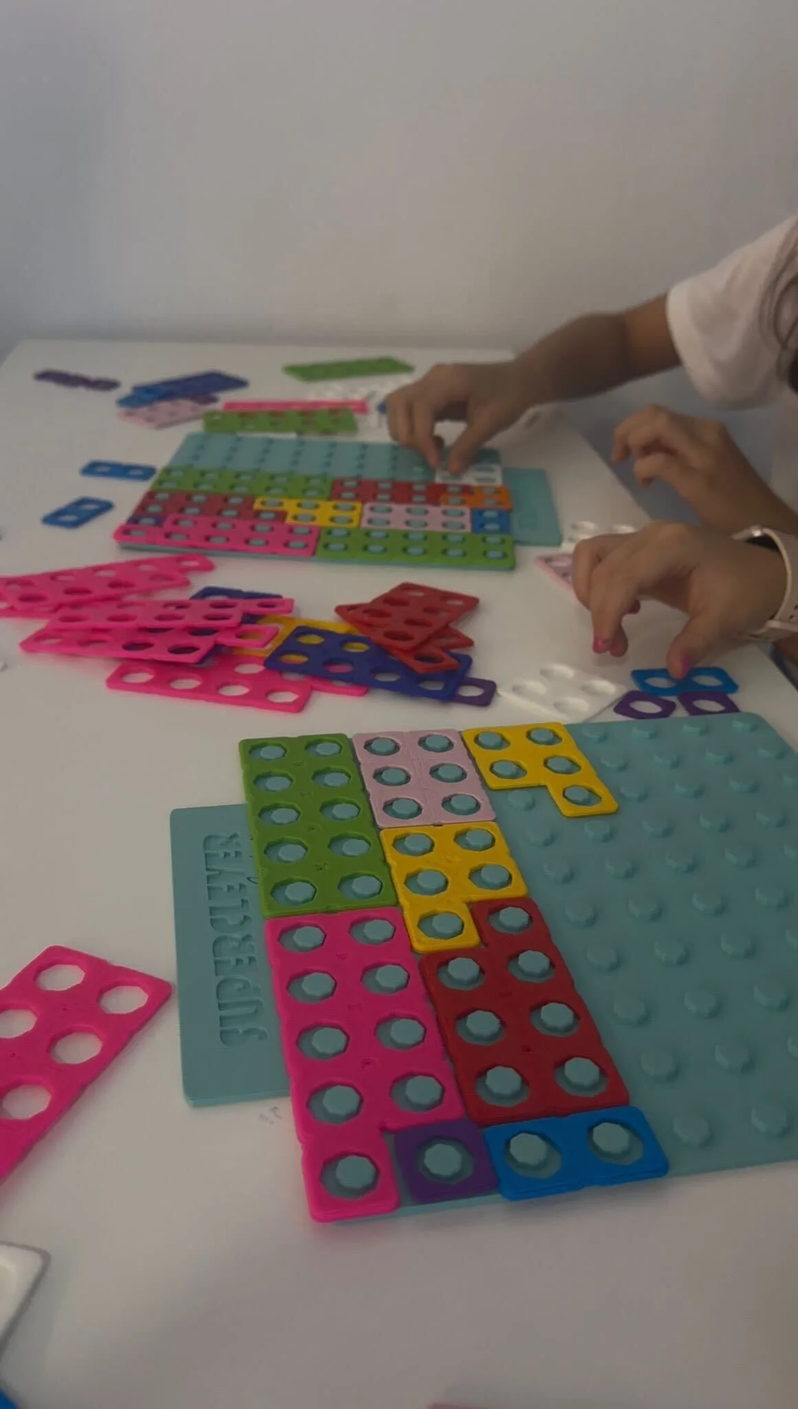 Small hands arranging number blocks
